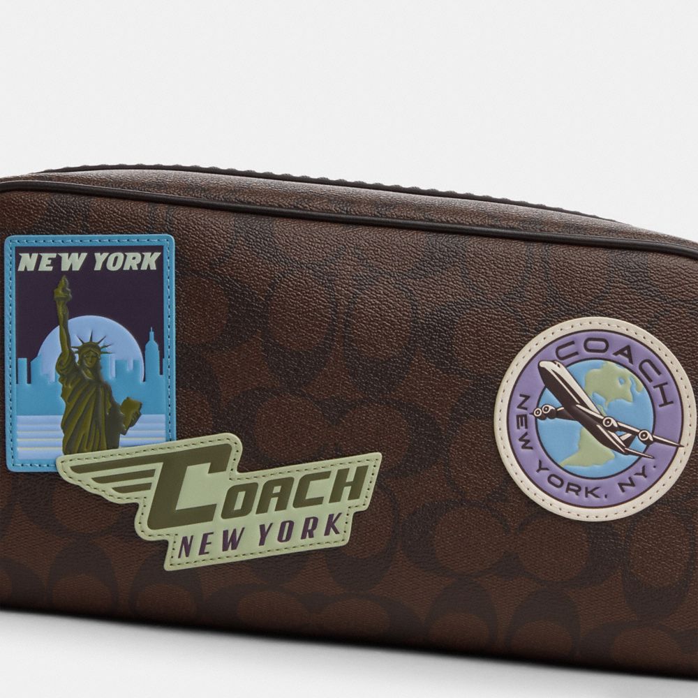 COACH®,LARGE TRAVEL KIT IN SIGNATURE CANVAS WITH TRAVEL PATCHES,Medium,Gunmetal/Mahogany Multi,Closer View