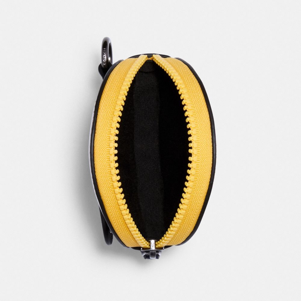 Pochette hybride ronde en toile signature à contraste de couleur avec écusson Coach