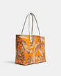 COACH®,REVERSIBLE CITY TOTE WITH BANANA LEAVES PRINT,pvc,Gold/Rdwd Snbem Multi/Redwood,Angle View