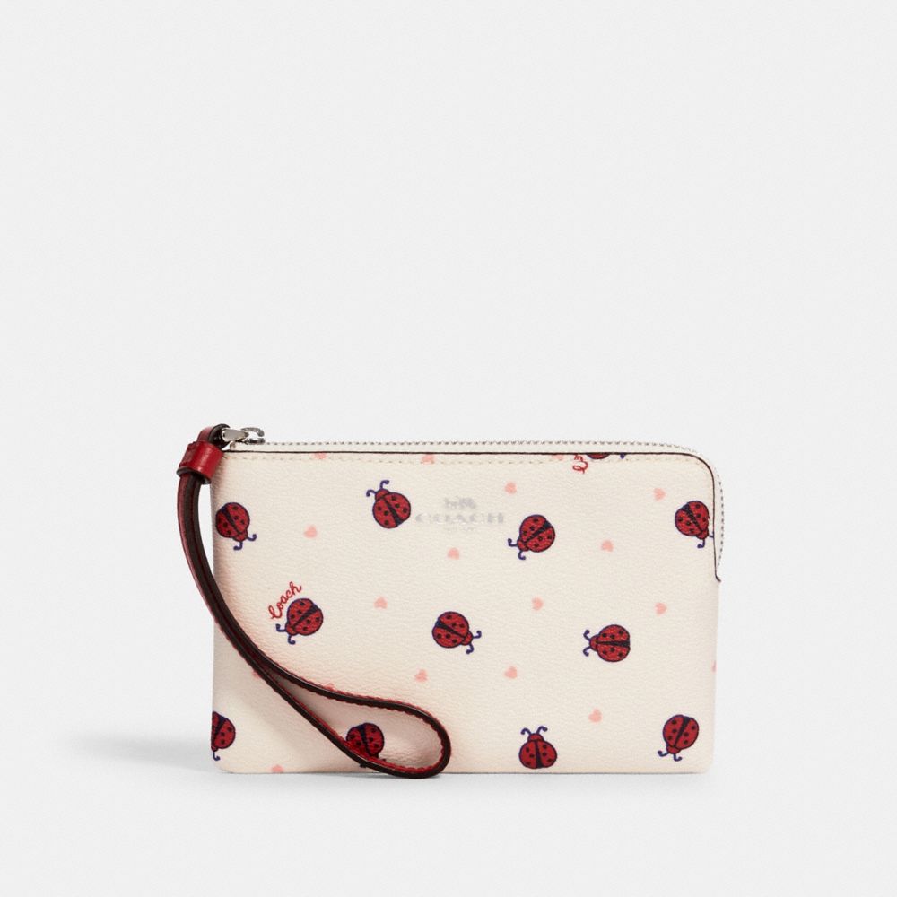 Wristlet à zip en coin et imprimé Coccinelle