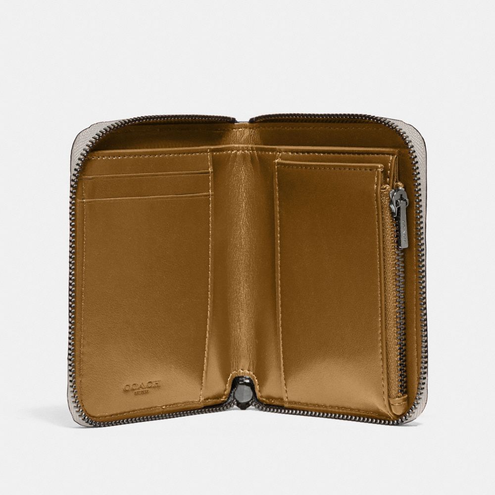 Petit portefeuille zippé avec rivets