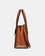 COACH®,CHARLIE CARRYALL 28 IN SIGNATURE CANVAS,Signature Coated Canvas,Medium,Brass/Rust,Angle View