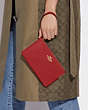 COACH®,LARGE CORNER ZIP WRISTLET,Leather,Medium,Gold/Red Apple,Detail View