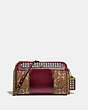 COACH®,JONI CROSSBODY IN SIGNATURE JACQUARD WITH PYRAMID RIVETS,Coated Canvas,Small,Brass/Tan/Scarlet,Front View