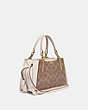 COACH®,DREAMER 21 IN SIGNATURE CANVAS,Coated Canvas,Medium,Brass/Tan/Chalk,Angle View