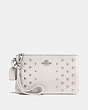 COACH®,SMALL WRISTLET IN POLISHED PEBBLE LEATHER WITH OMBRE RIVETS,Leather,Silver/Chalk,Front View