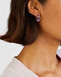 COACH®,CRYSTAL TEA ROSE HUGGIE EARRINGS,n/a,Silver/Purple,Angle View