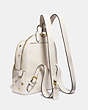 COACH®,CARRIE BACKPACK 23 WITH APPLE PRINT,Pebble Leather,Medium,Brass/Chalk Multi,Angle View