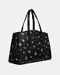 COACH®,CHARLIE CARRYALL WITH FLORAL PRINT,Leather,Large,Gold/Black,Angle View