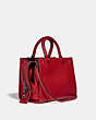 COACH®,DISNEY X COACH ROGUE 25 WITH PATCHES,Pebble Leather/Smooth Leather,Medium,Pewter/1941 Red,Angle View