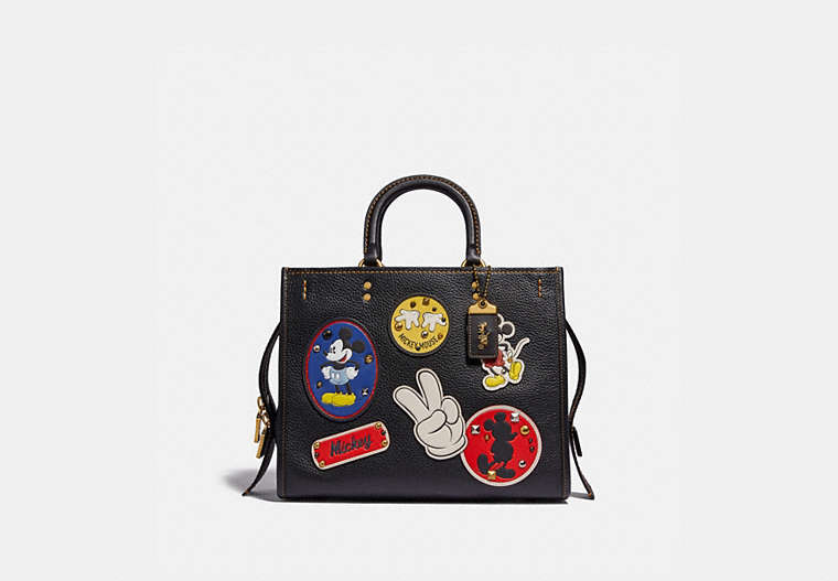 COACH®,DISNEY X COACH ROGUE WITH PATCHES,Pebble Leather/Smooth Leather,Medium,Brass/Black,Front View