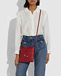 COACH®,DISNEY X COACH KITT MESSENGER CROSSBODY BAG WITH DISNEY MOTIF,Leather,Small,Pewter/1941 Red,Detail View