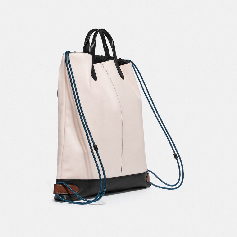 COACH®,ACADEMY DRAWSTRING BACKPACK IN COLORBLOCK,Leather,Medium,Black Copper/Chalk/Black,Angle View