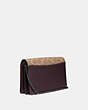 COACH®,CALLIE FOLDOVER CHAIN CLUTCH IN SIGNATURE CANVAS WITH REXY BY YETI OUT,pvc,Mini,Pewter/Tan Oxblood,Angle View