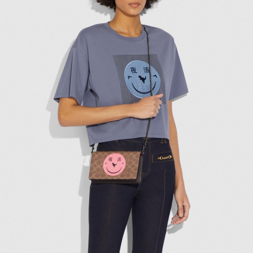 COACH®,Callie Foldover Chain Clutch In Signature Canvas With Rexy By Yeti Out,,Detail View