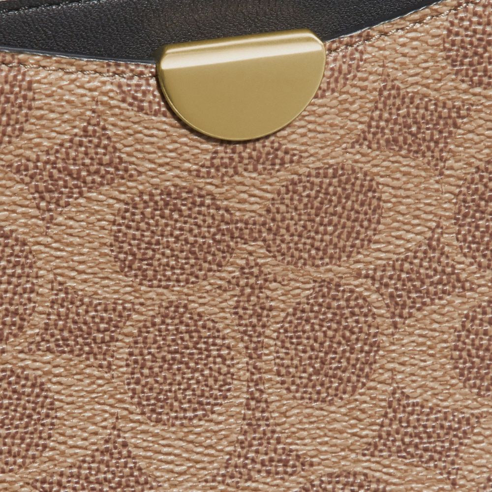 COACH®,DREAMER WRISTLET IN SIGNATURE CANVAS,Coated Canvas,Brass/Tan Black,Closer View