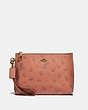 COACH®,DISNEY X COACH CHARLIE POUCH WITH MIXED DALMATIAN PRINT,Smooth Leather,Brass/Light Peach,Front View