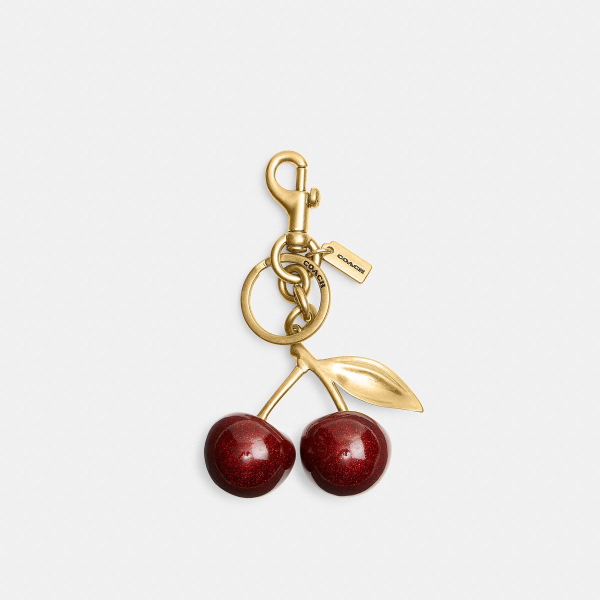 Coach glittery red cherry resin bag charm gold clasp