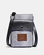 COACH®,HYBRID POUCH IN REFLECTIVE SIGNATURE CANVAS,Signature Coated Canvas/Leather,Silver/Saddle/Black,Front View