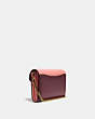COACH®,TABBY CHAIN CLUTCH IN COLORBLOCK SIGNATURE CANVAS,Signature Coated Canvas/Smooth Leather,Mini,Brass/Tan Wine Multi,Angle View