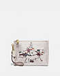 COACH®,CHARLIE POUCH IN SIGNATURE CANVAS WITH BONESY,Signature Coated Canvas,Brass/Ivory Multi,Front View