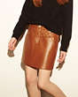 COACH®,CURVED HEM SKIRT,Leather,Saddle,Front View