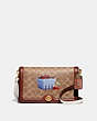 COACH®,RILEY IN SIGNATURE CANVAS BY ANNA SUDIT,Coated Canvas,Small,Brass/Rust,Front View