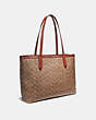 COACH®,CENTRAL TOTE WITH ZIP IN SIGNATURE CANVAS BY TYLER SPANGLER,Coated Canvas,Large,Brass/Tan/Rust,Angle View