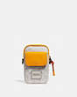 COACH®,PACER CONVERTIBLE POUCH IN COLORBLOCK SIGNATURE CANVAS WITH COACH PATCH,pvc,Mini,Chalk/Pollen,Front View