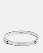 COACH®,DAISY RIVET COACH TENSION BANGLE,Mixed Metal,Silver,Front View