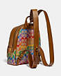 COACH®,CARRIE BACKPACK 23 IN RAINBOW SIGNATURE CANVAS,Coated Canvas,Brass/Tan Penny Multi,Angle View