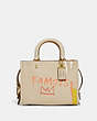 COACH®,COACH X JEAN-MICHEL BASQUIAT ROGUE BAG 25,Leather,Medium,Brass/Ivory,Front View