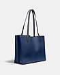 COACH®,WILLOW TOTE IN COLORBLOCK WITH SIGNATURE CANVAS INTERIOR,Pebble Leather,Large,Brass/Deep Blue Multi,Angle View