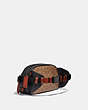 COACH®,HITCH BELT BAG IN SIGNATURE CANVAS WITH HORSE AND CARRIAGE PRINT,Signature Coated Canvas,Medium,Black Copper/Truffle Multi,Angle View