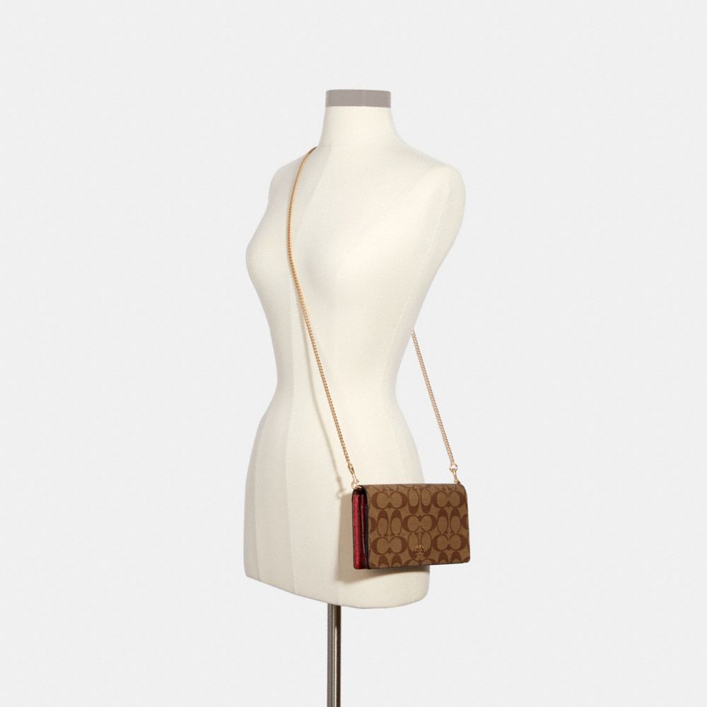 Boxed anna foldover crossbody best sale clutch in signature canvas