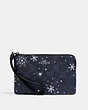 COACH®,CORNER ZIP WRISTLET IN SIGNATURE CANVAS WITH SNOWFLAKE PRINT,Silver/Midnight Multi,Front View