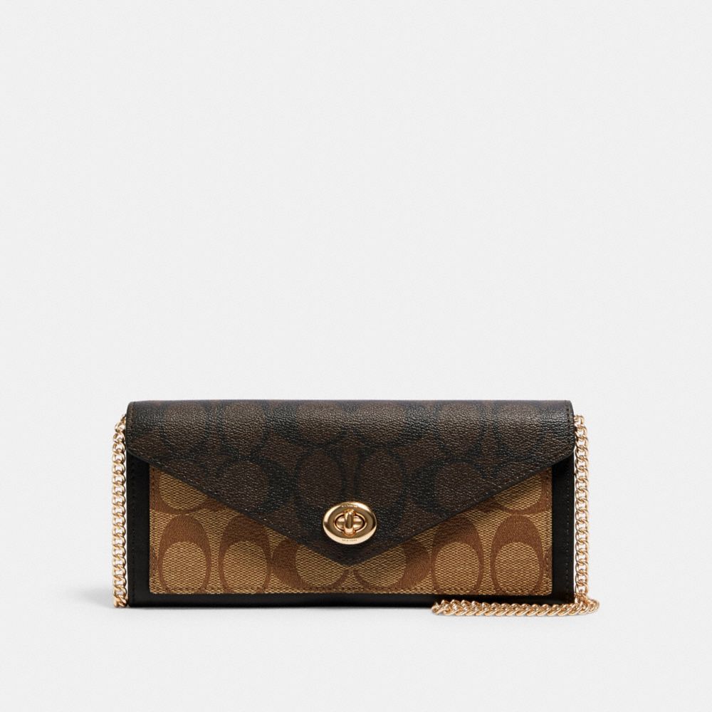 Coach envelope clutch in leather and coated canvas with logo