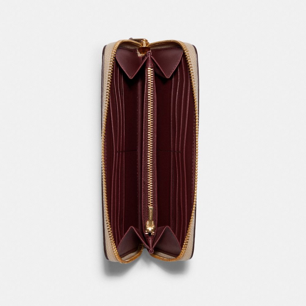 Portefeuille accordéon zippé Disney X Coach en toile Signature avec renforts