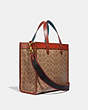 COACH®,LUNAR NEW YEAR FIELD TOTE IN SIGNATURE CANVAS WITH OX,Signature Coated Canvas,Large,Brass/Tan/Rust,Angle View