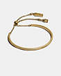 COACH®,SIGNATURE SLIDER BANGLE,Plated Brass,Gold,Front View