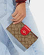 COACH®,PHONE WALLET IN COLORBLOCK SIGNATURE CANVAS,Im/Khaki/Electric Red,Detail View
