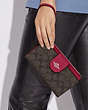 COACH®,PHONE WALLET IN COLORBLOCK SIGNATURE CANVAS,pvc,Silver/Brown/Bright Violet,Detail View