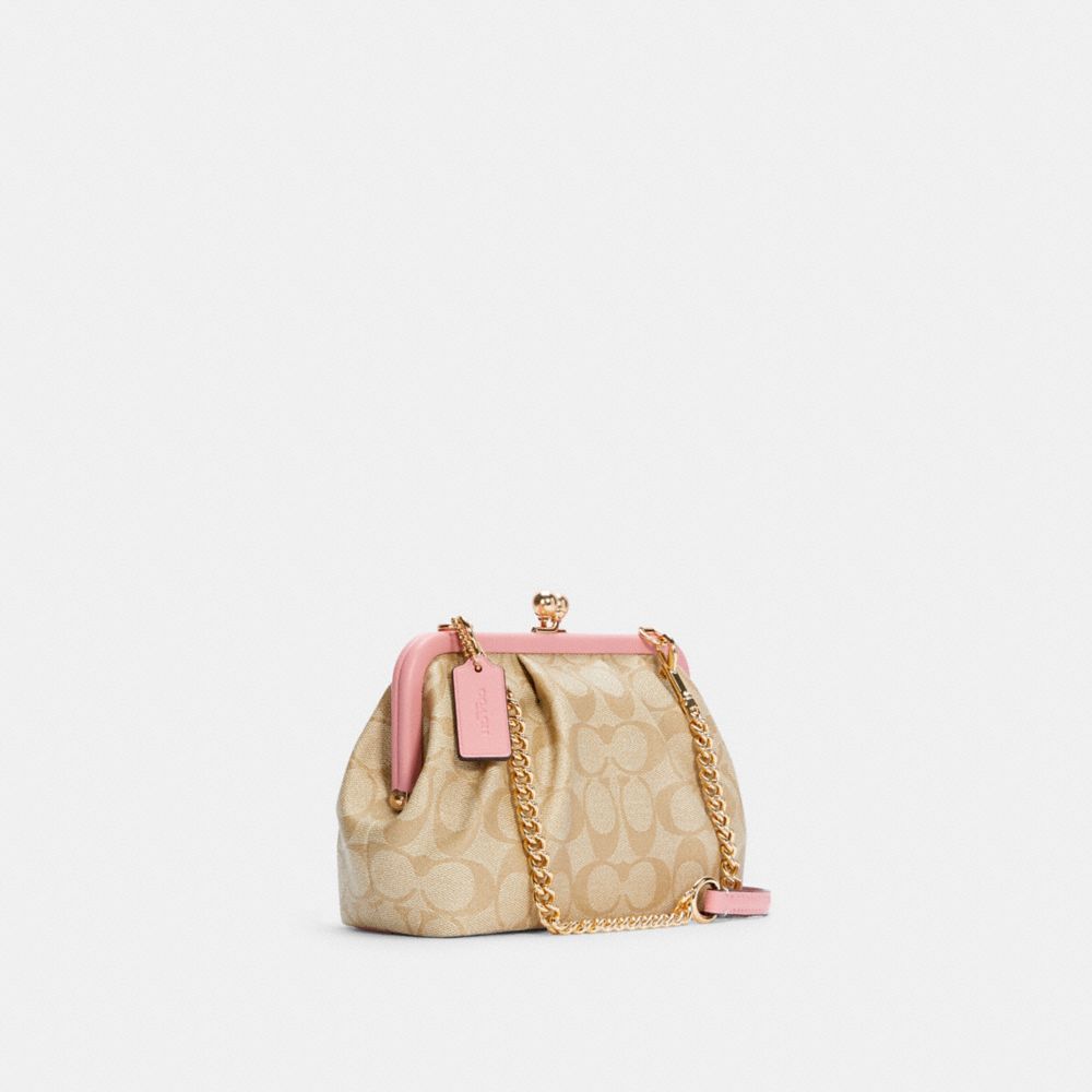 COACH®,Nora Kisslock Crossbody In Signature Canvas,,Angle View