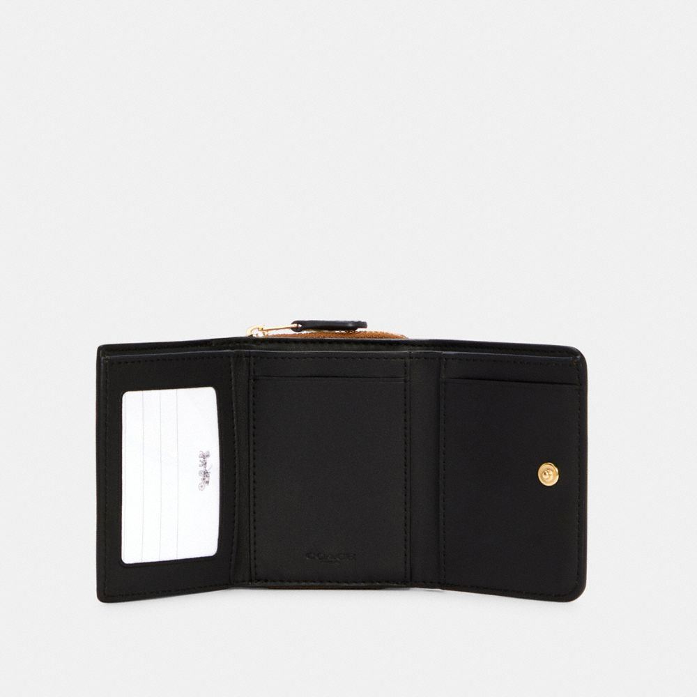 small trifold wallet in colorblock signature canvas with rivets