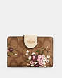 COACH®,MEDIUM CORNER ZIP WALLET IN SIGNATURE CANVAS WITH EVERGREEN FLORAL PRINT,Gold/Khaki Multi,Front View