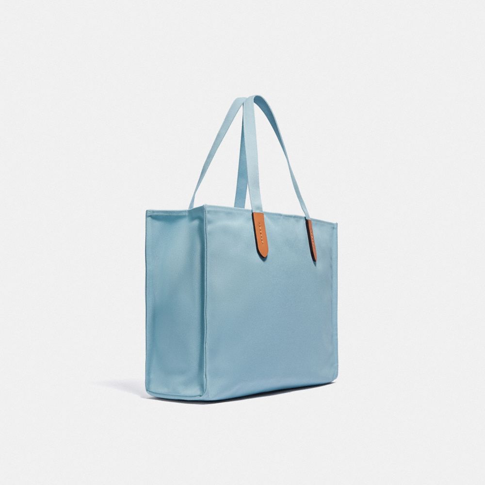 COACH®,TOTE 42 IN 100 PERCENT RECYCLED CANVAS,Recycled Canvas,Large,Brass/Celestial Blue,Angle View