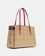 COACH®,TATUM CARRYALL 40 IN SIGNATURE CANVAS,n/a,X-Large,Gold/Light Khaki/Confetti Pink,Angle View