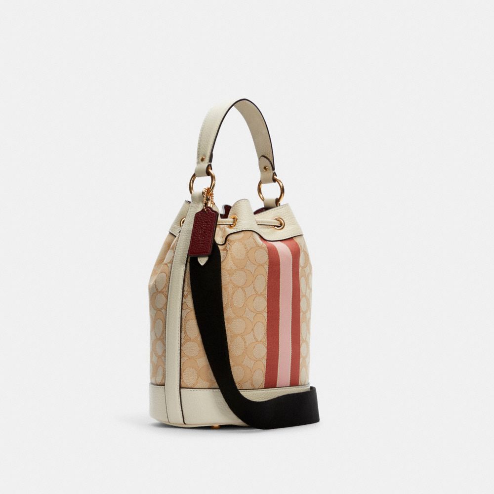 COACH®,DEMPSEY DRAWSTRING BUCKET BAG IN SIGNATURE JACQUARD WITH STRIPE AND COACH PATCH,Jacquard,Medium,Gold/Lt Khaki/Powder Pink Multi,Angle View