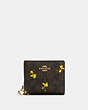 COACH®,COACH X PEANUTS SNAP WALLET IN SIGNATURE CANVAS WITH WOODSTOCK PRINT,pvc,Mini,Gold/Brown Black Multi,Front View