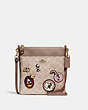 COACH®,DISNEY X COACH KITT MESSENGER CROSSBODY BAG IN SIGNATURE CANVAS WITH PATCHES,Signature Coated Canvas/Pebb...,Brass/Sand Taupe,Front View